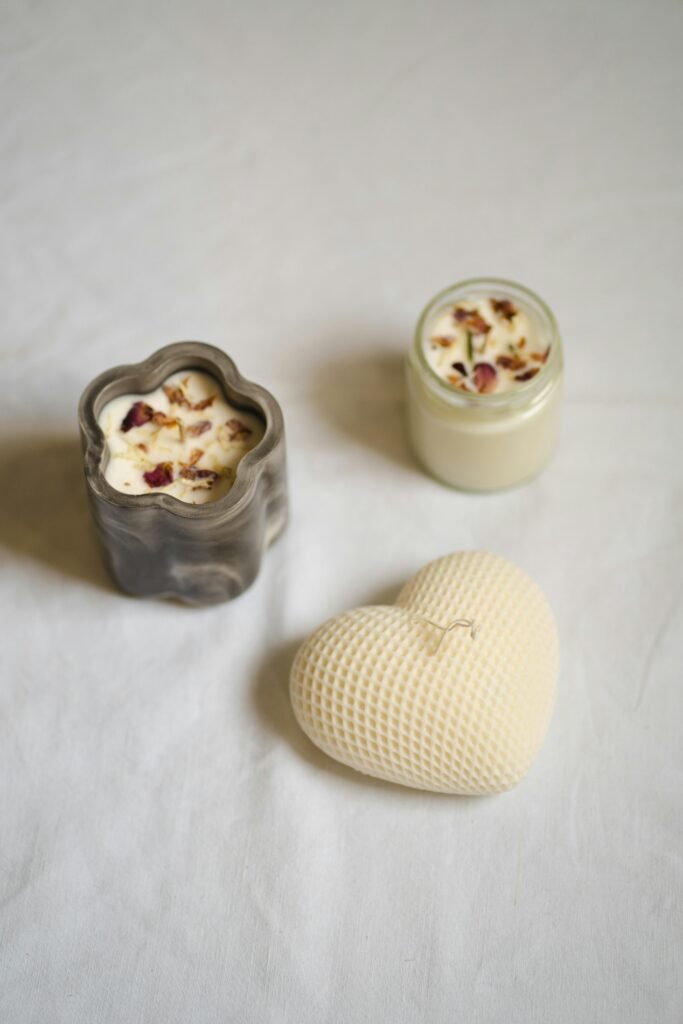 A minimalist still life featuring artisan candles in unique shapes, creating a serene and elegant atmosphere.
